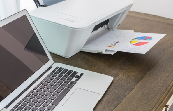 printer and Laptop on wood table