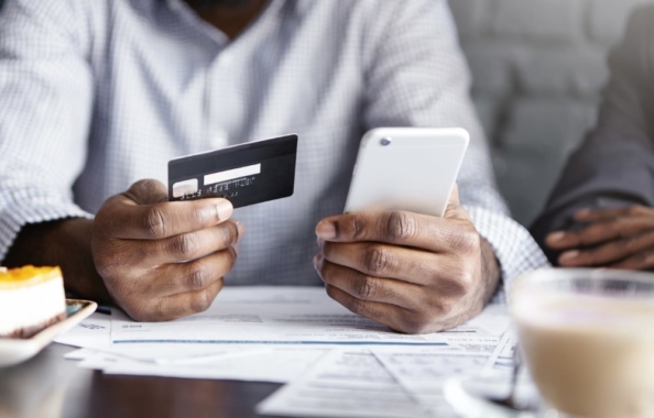 Person-Holding-Credit-Card-and-Mobile