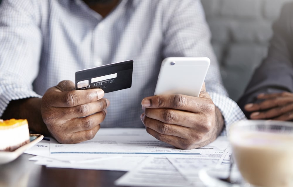Person-Holding-Credit-Card-and-Mobile
